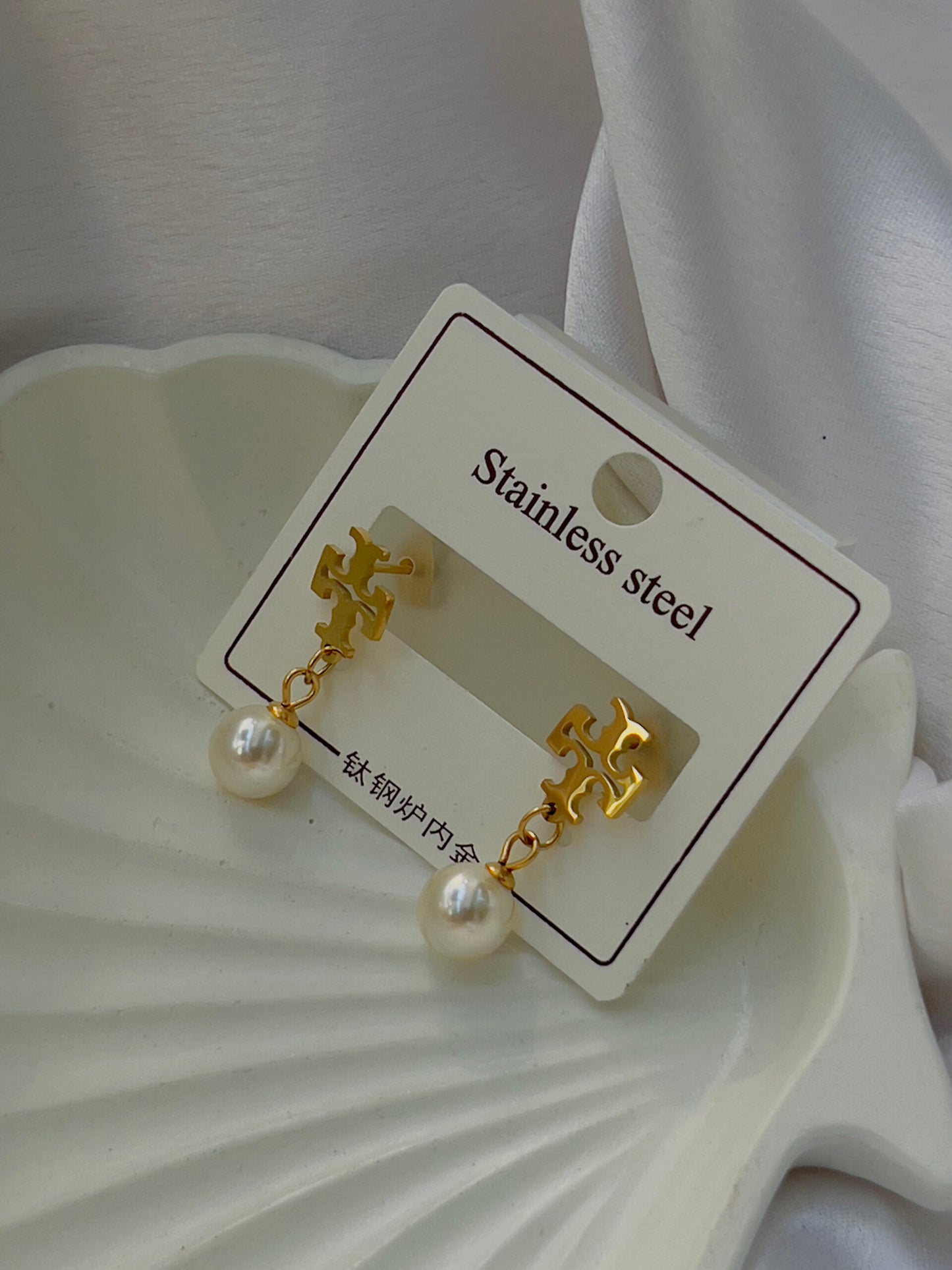 Tory with pearl earrings
