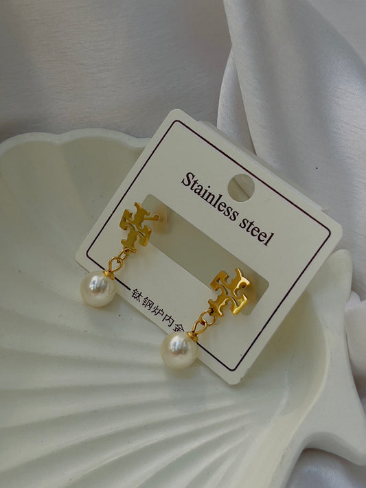 Tory with pearl earrings