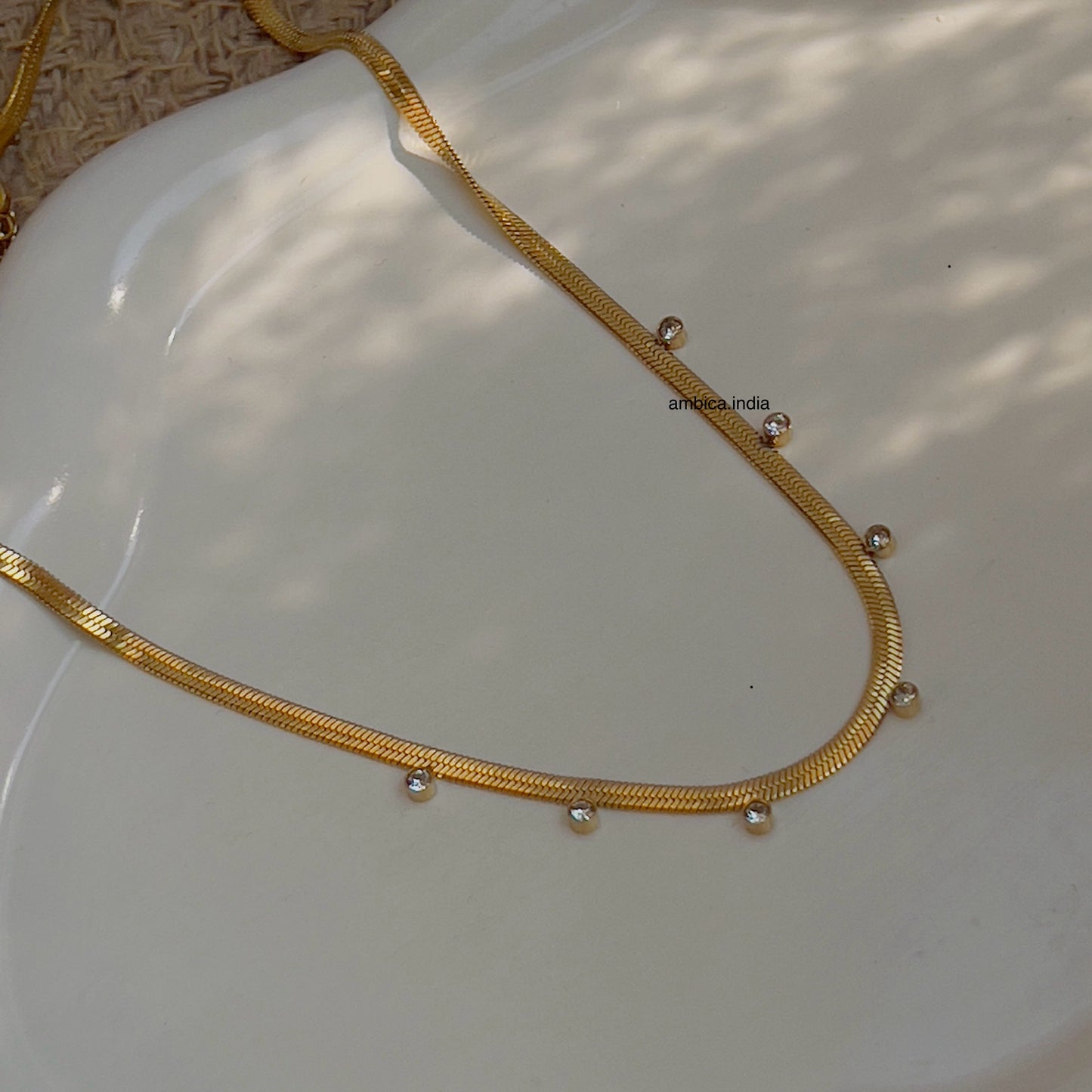 Small white crystal with snake chain
